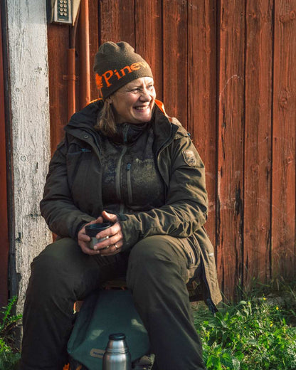 Green Orange Coloured Pinewood Melange Hat on outdoor background 