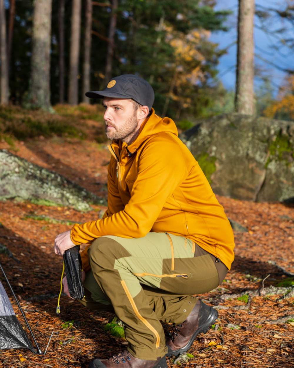 Leaf Hunting Olive Coloured Pinewood Mens Abisko Brenton Trousers on forest background 