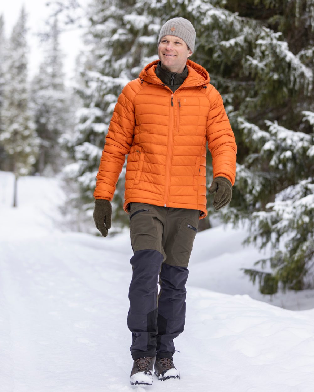 Burned Orange Coloured Pinewood Mens Abisko Insulation Jacket on snow background 