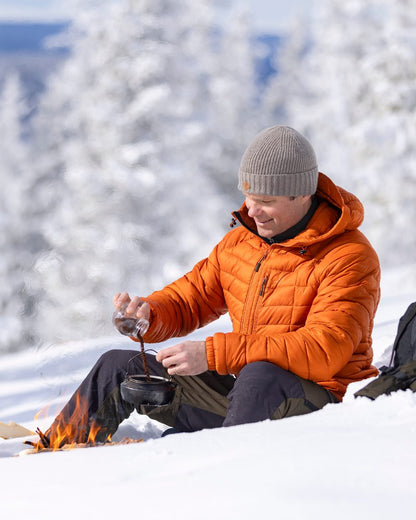 Burned Orange Coloured Pinewood Mens Abisko Insulation Jacket on snow background 