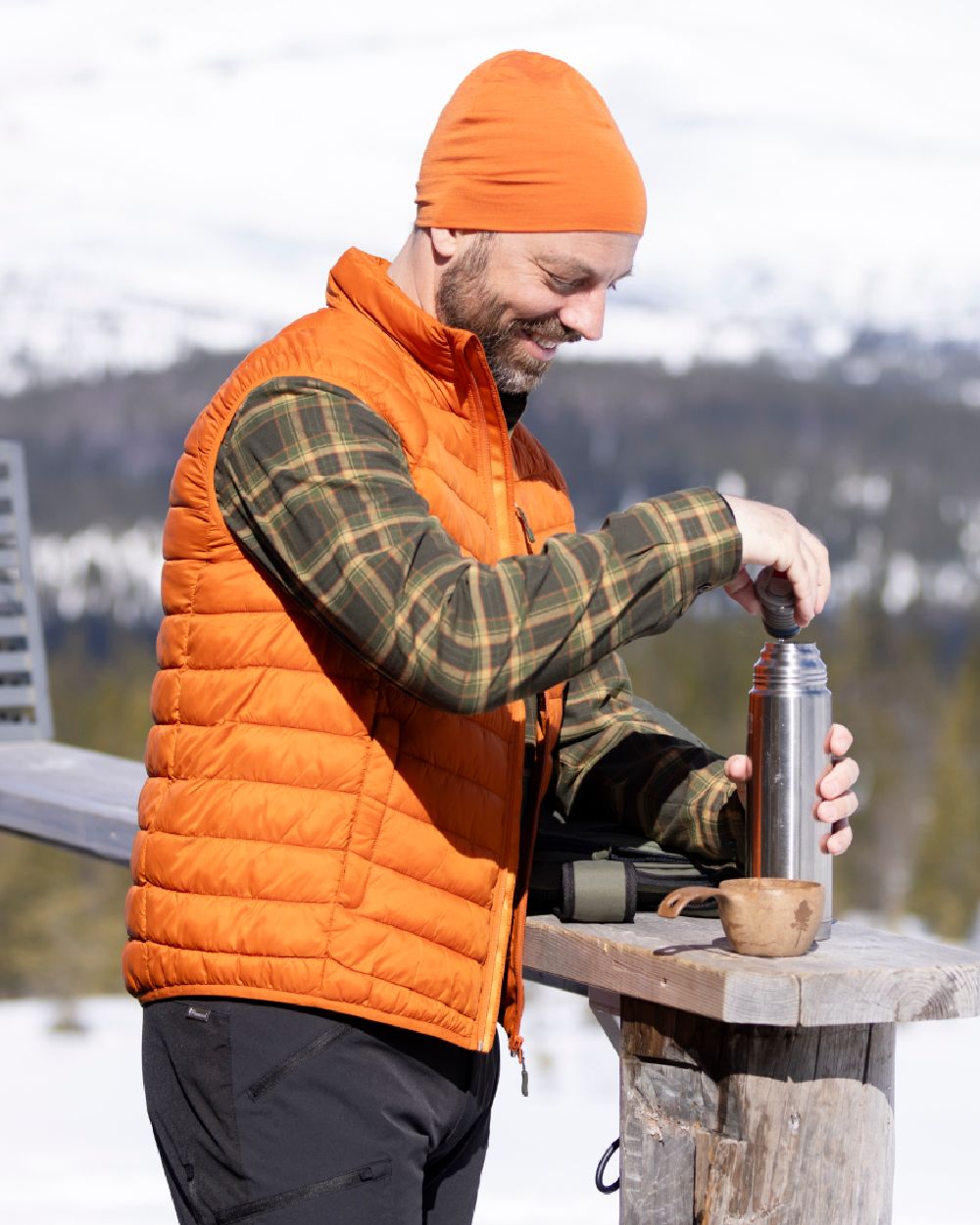 Burned Orange Coloured Pinewood Mens Abisko Insulation Vest on snow background 
