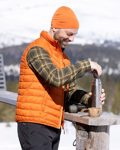 Burned Orange Coloured Pinewood Mens Abisko Insulation Vest on snow background 