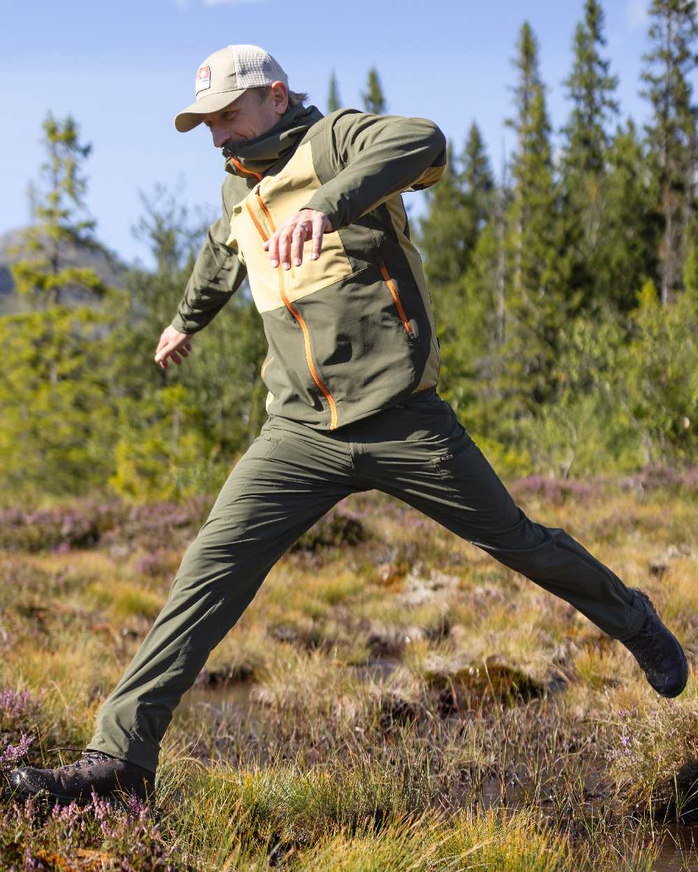 Mossgreen Coloured Pinewood Mens Abisko Light Stretch Trousers on outdoor background 