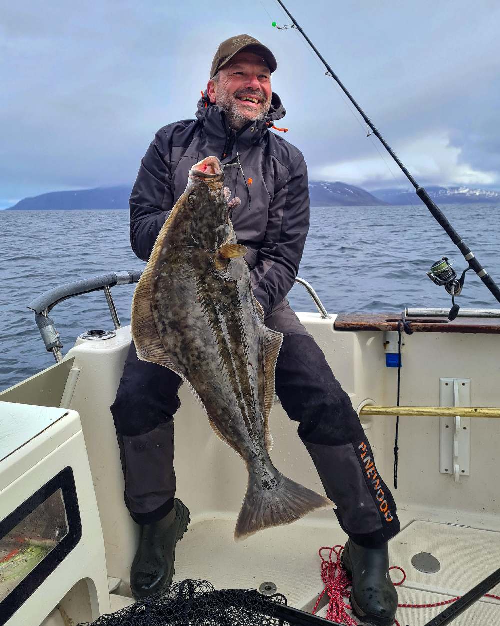 Dark Anthracite Black Coloured Pinewood Mens Bolmen Fishing Bib Trousers on sea background 