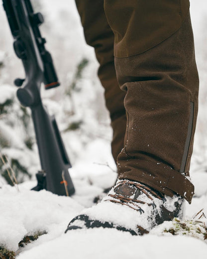 Suede Brown Dark Olive Coloured Pinewood Mens Caribou Hunt Extreme Trousers on snow background 