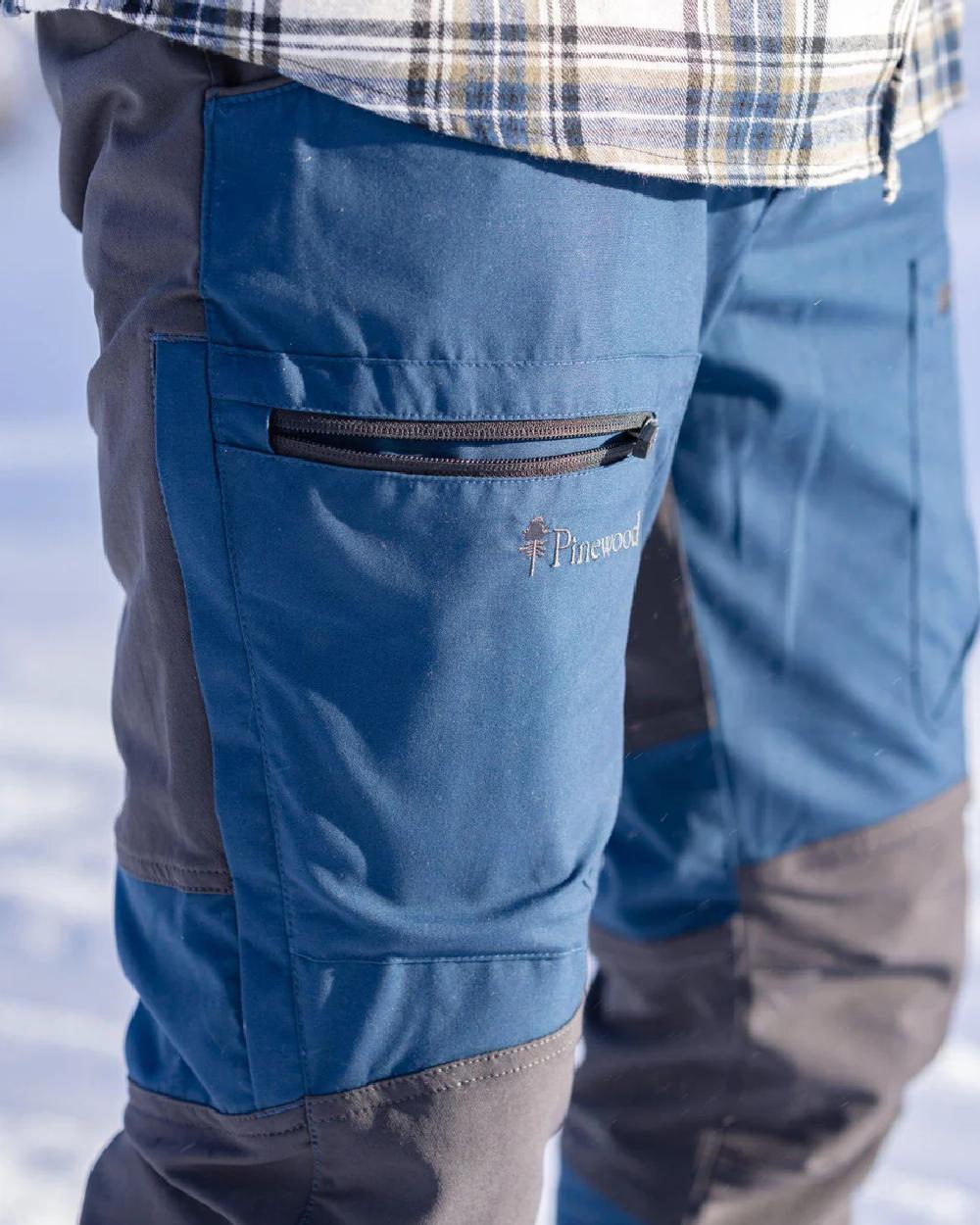 Dark Dive Dark Anthracite coloured Pinewood Mens Caribou TC Trousers  on blurry background 