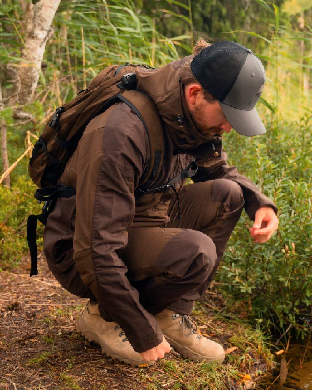 Dark Brown Coloured Pinewood Mens Finnveden Hybrid Jacket on outdoor background 