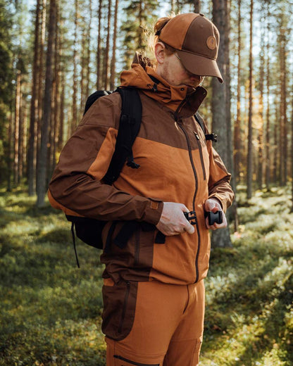 Fudge Nougat Coloured Pinewood Mens Finnveden Hybrid Jacket on outdoor background 