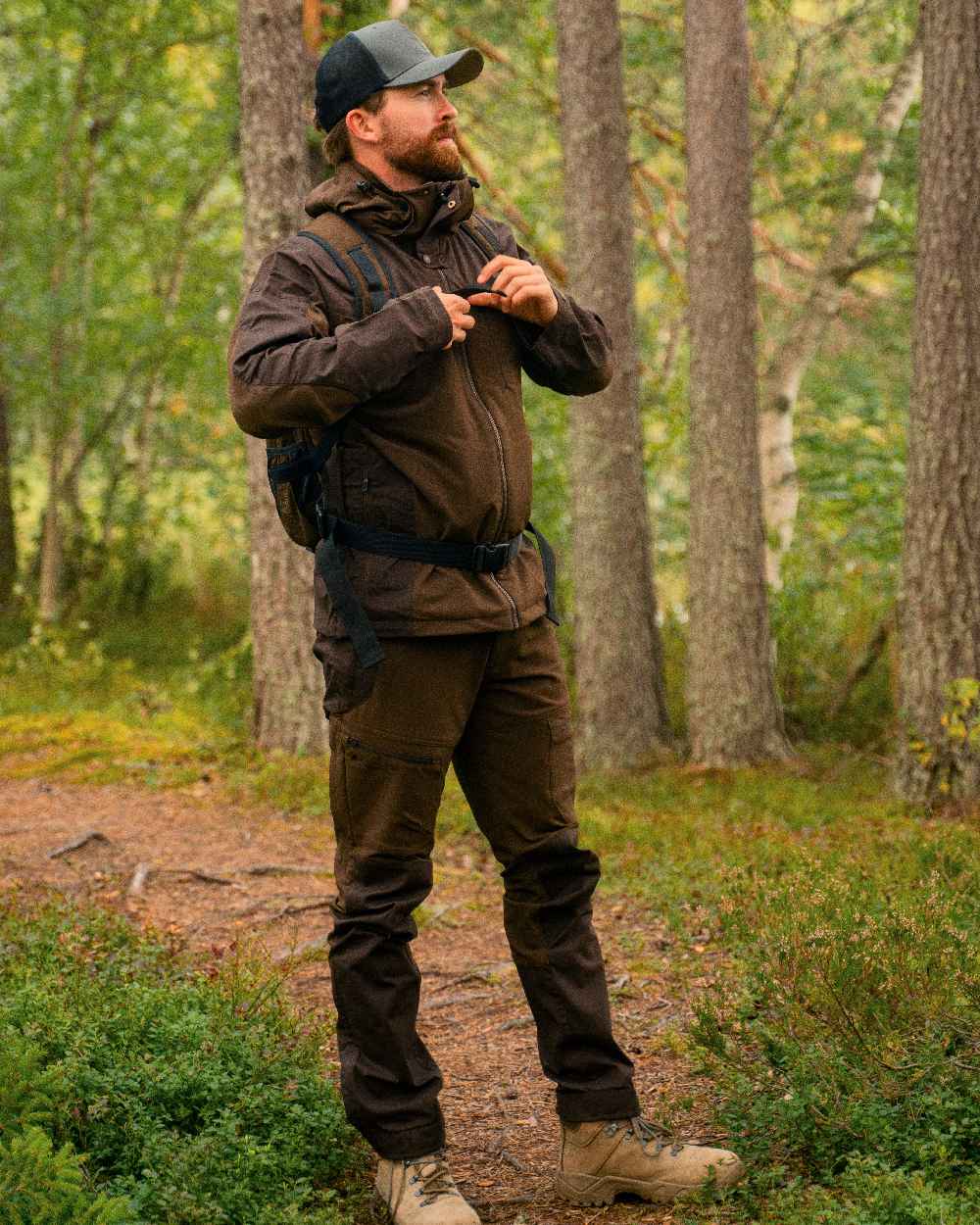 Dark Brown Coloured Pinewood Mens Finnveden Hybrid Trousers on outdoor background 