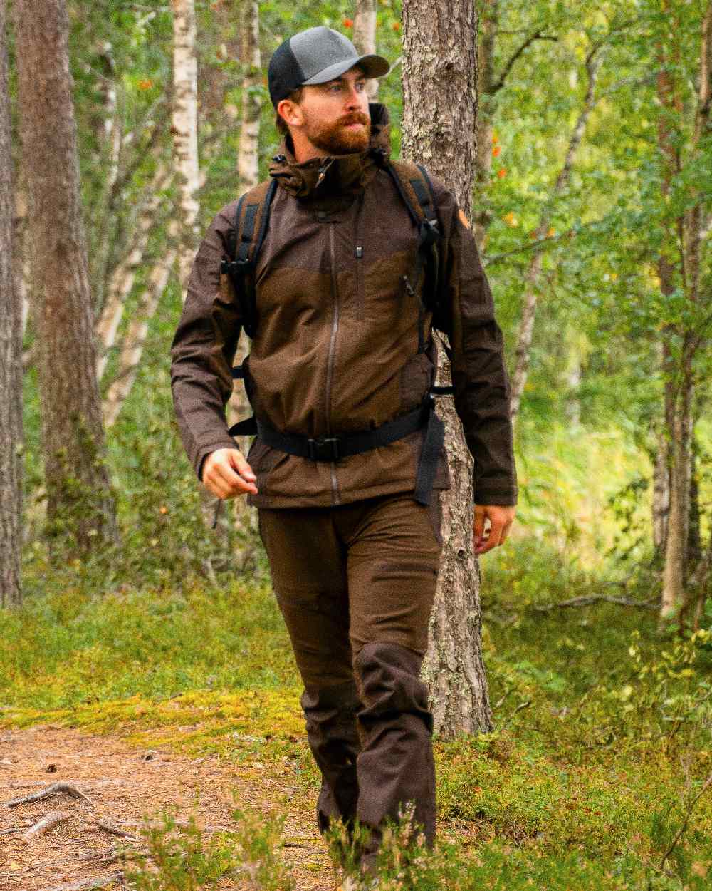 Dark Brown Coloured Pinewood Mens Finnveden Hybrid Trousers on outdoor background 