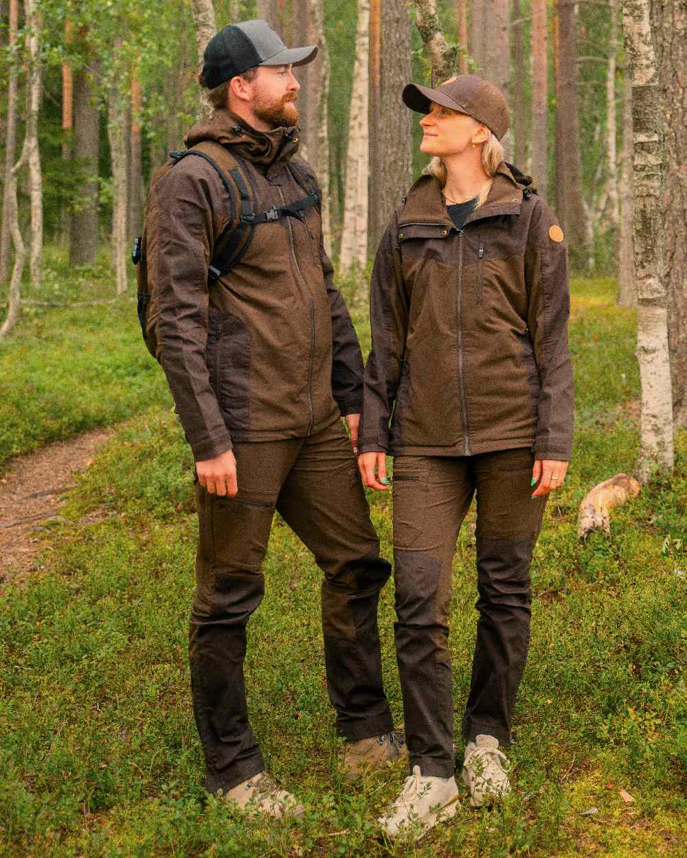Dark Brown Coloured Pinewood Mens Finnveden Hybrid Trousers on outdoor background 