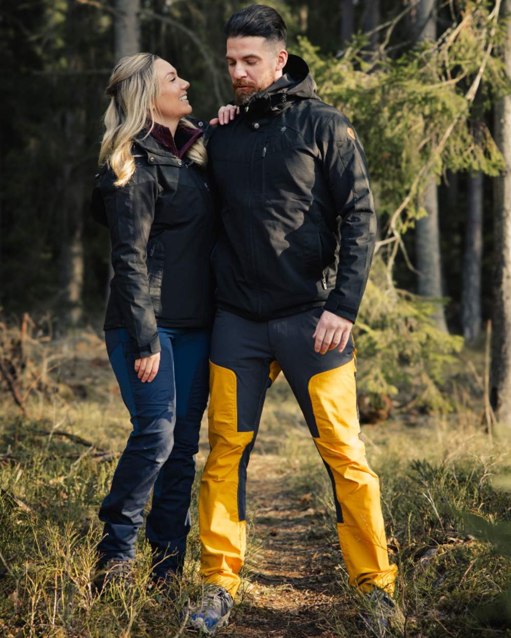 Black coloured Pinewood Mens Finnveden Hybrid Jacket on forest background 