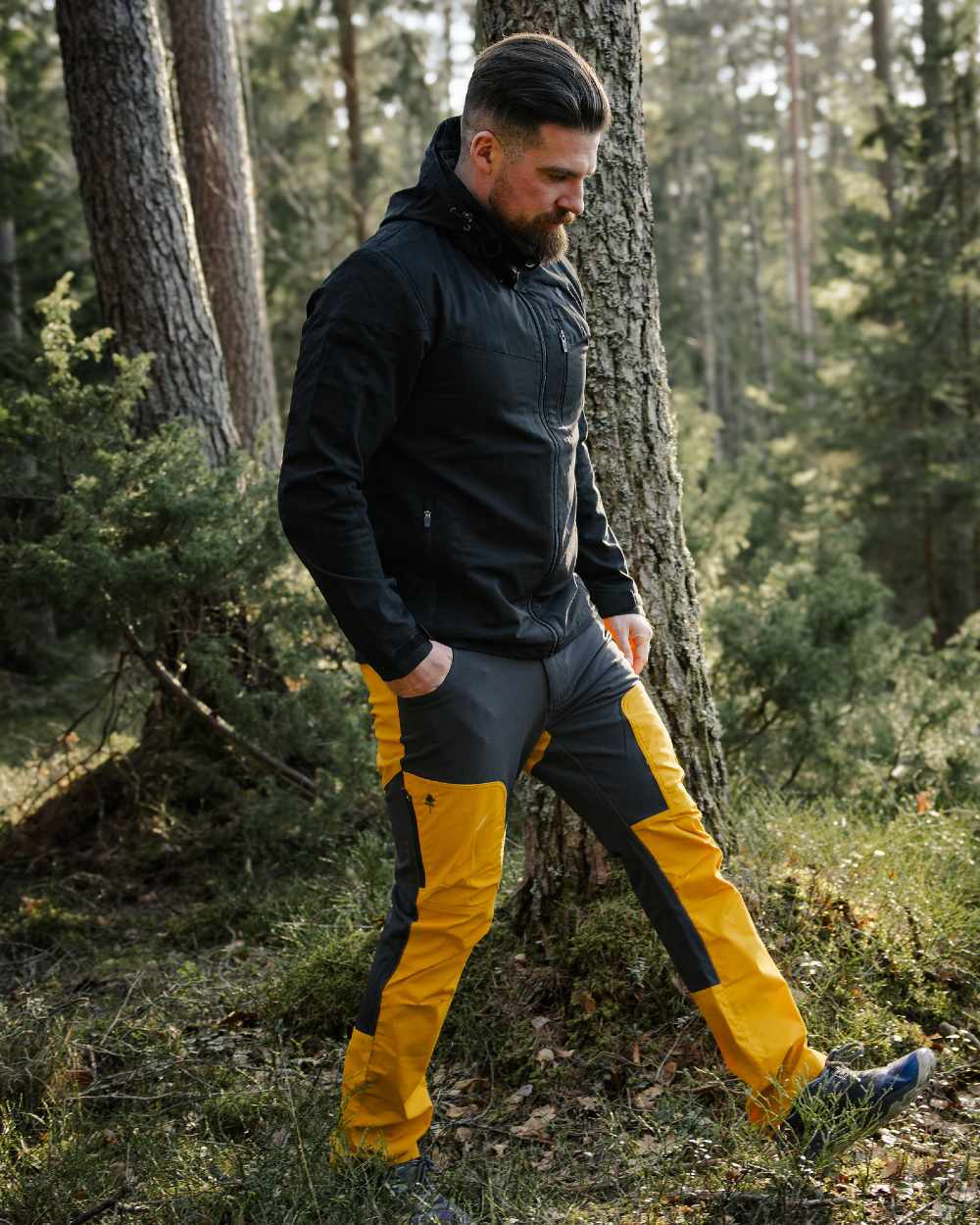 Black coloured Pinewood Mens Finnveden Hybrid Jacket on forest background 