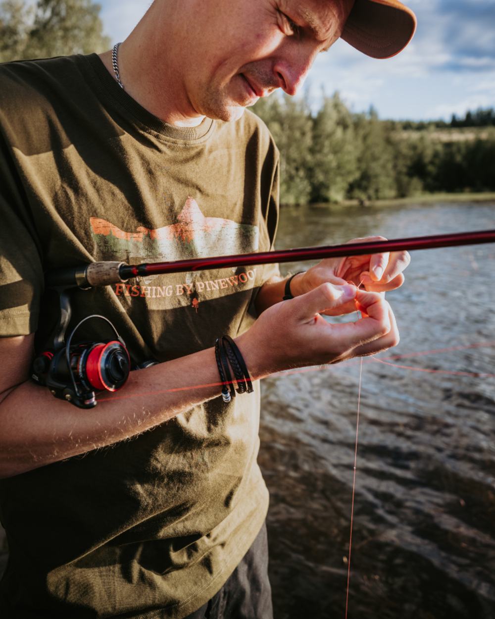 Green coloured Pinewood Mens Fish T-Shirt on lake background 