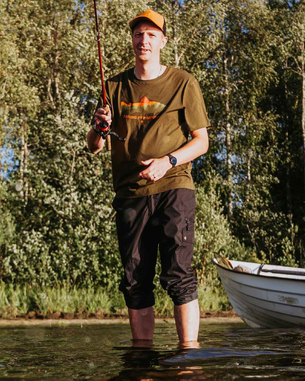 Green coloured Pinewood Mens Fish T-Shirt on lake background 
