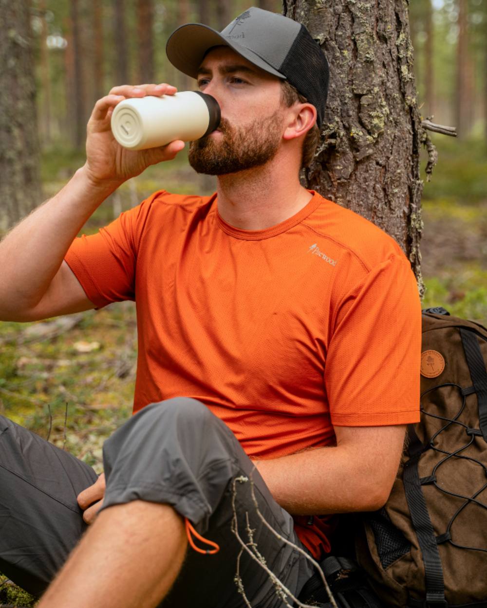 Burned Orange coloured Pinewood Mens Function T-Shirt on forest background 