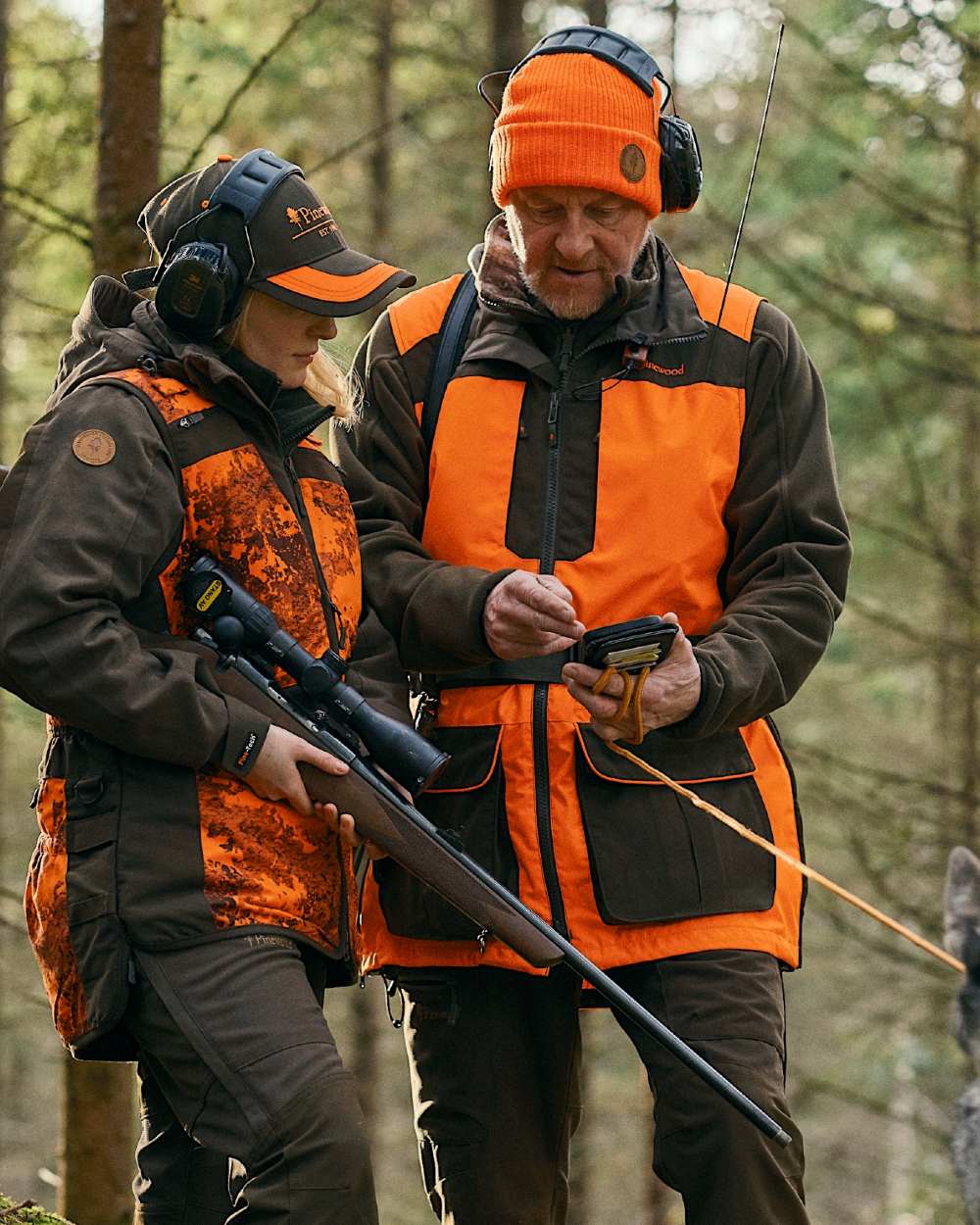 Orange Moss Green coloured Pinewood Mens Furudal Dog Handler Vest on forest background 