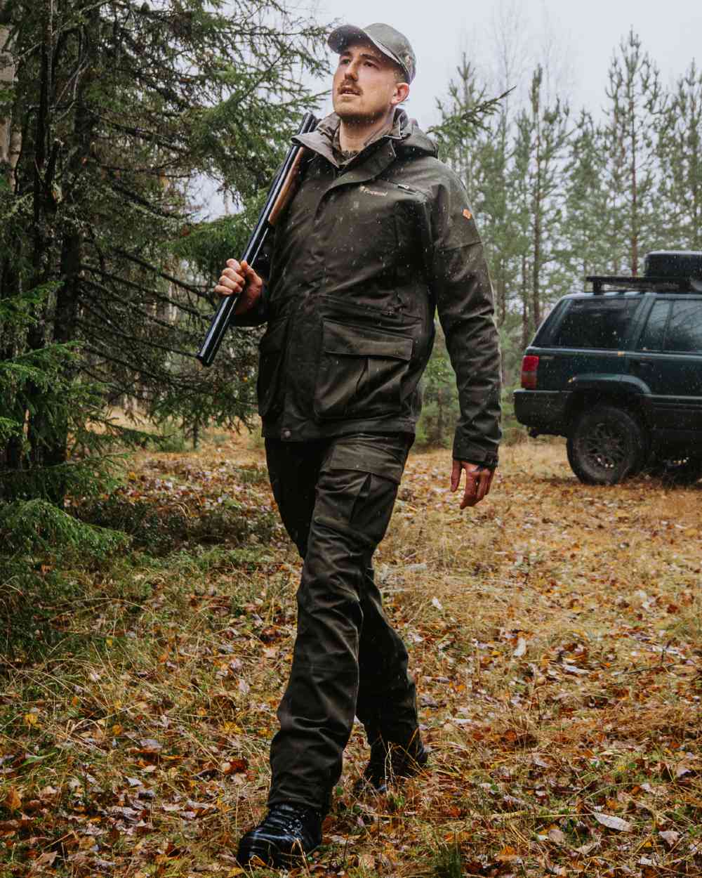 Dark Moss Green coloured Pinewood Mens Furudal Expert 2L Hunting Jacket on forest background 