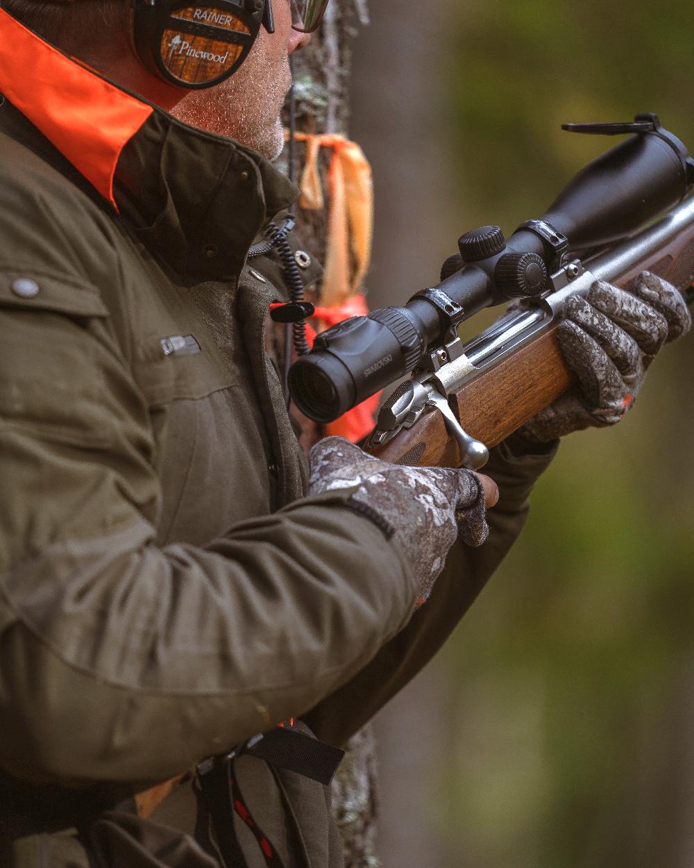 Moss Green coloured Pinewood Mens Hunter Pro Xtreme 2.0 Jacket on forest background 