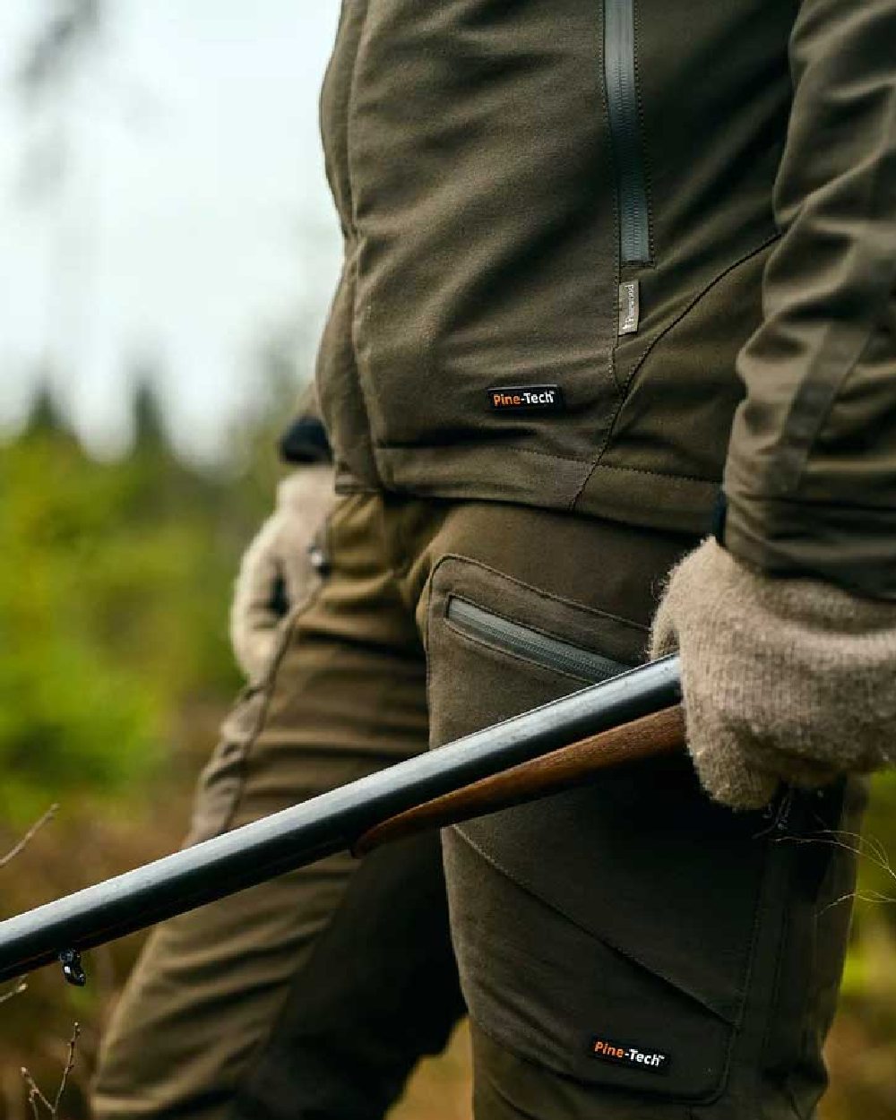 Moss Green coloured Pinewood Mens Hunter Pro Xtreme 2.0 Jacket on forest background 