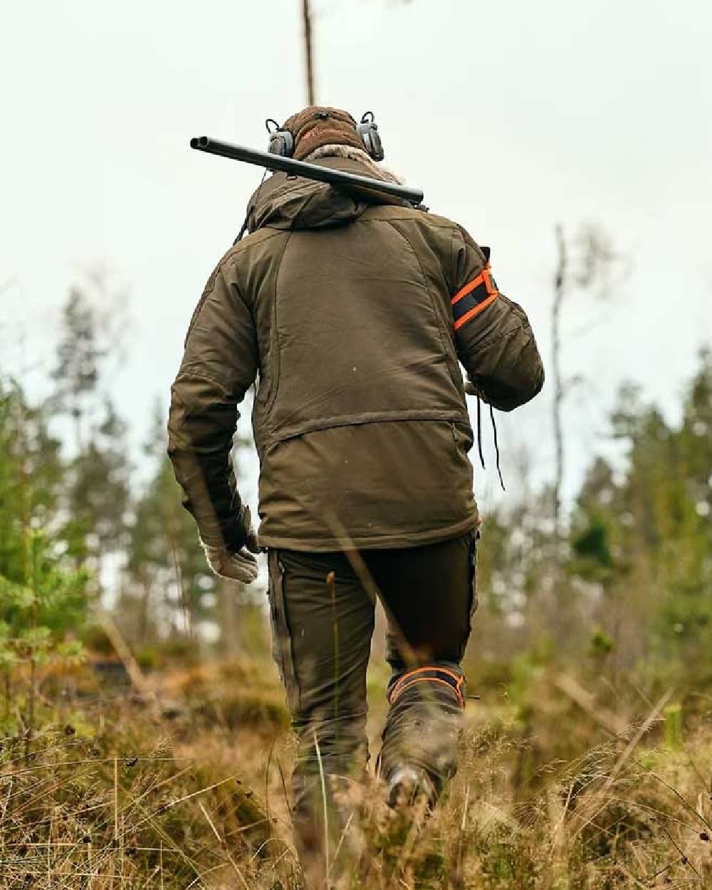 Moss Green coloured Pinewood Mens Hunter Pro Xtreme 2.0 Jacket on forest background 