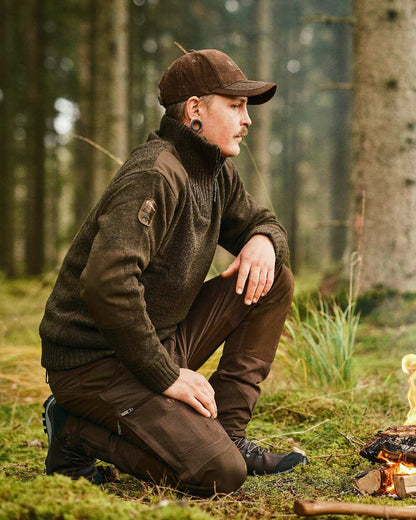 Dark Green Mel Coloured Pinewood Mens Hurricane Sweater on outdoor background 