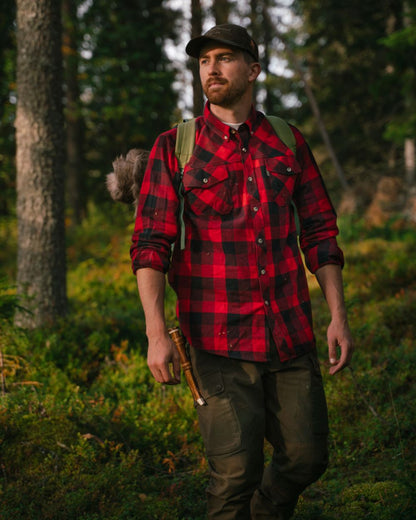 Red Black coloured Pinewood Mens Lumbo Shirt on forest background 