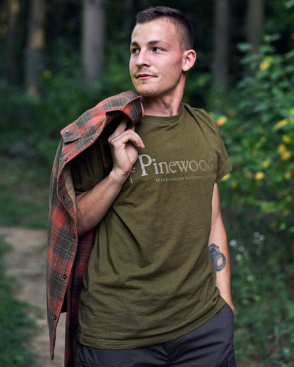 Hunter Olive coloured Pinewood Mens Outdoor Life T-Shirt on forest background 