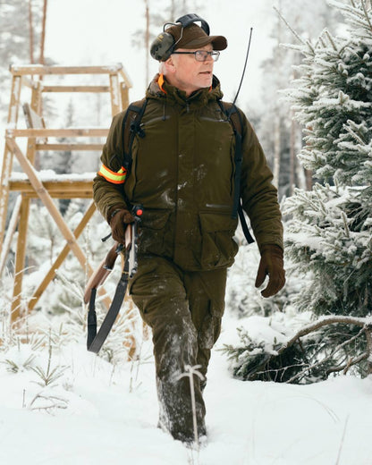 Hunting Green coloured Pinewood Mens Smaland Forest Trousers on snow background 