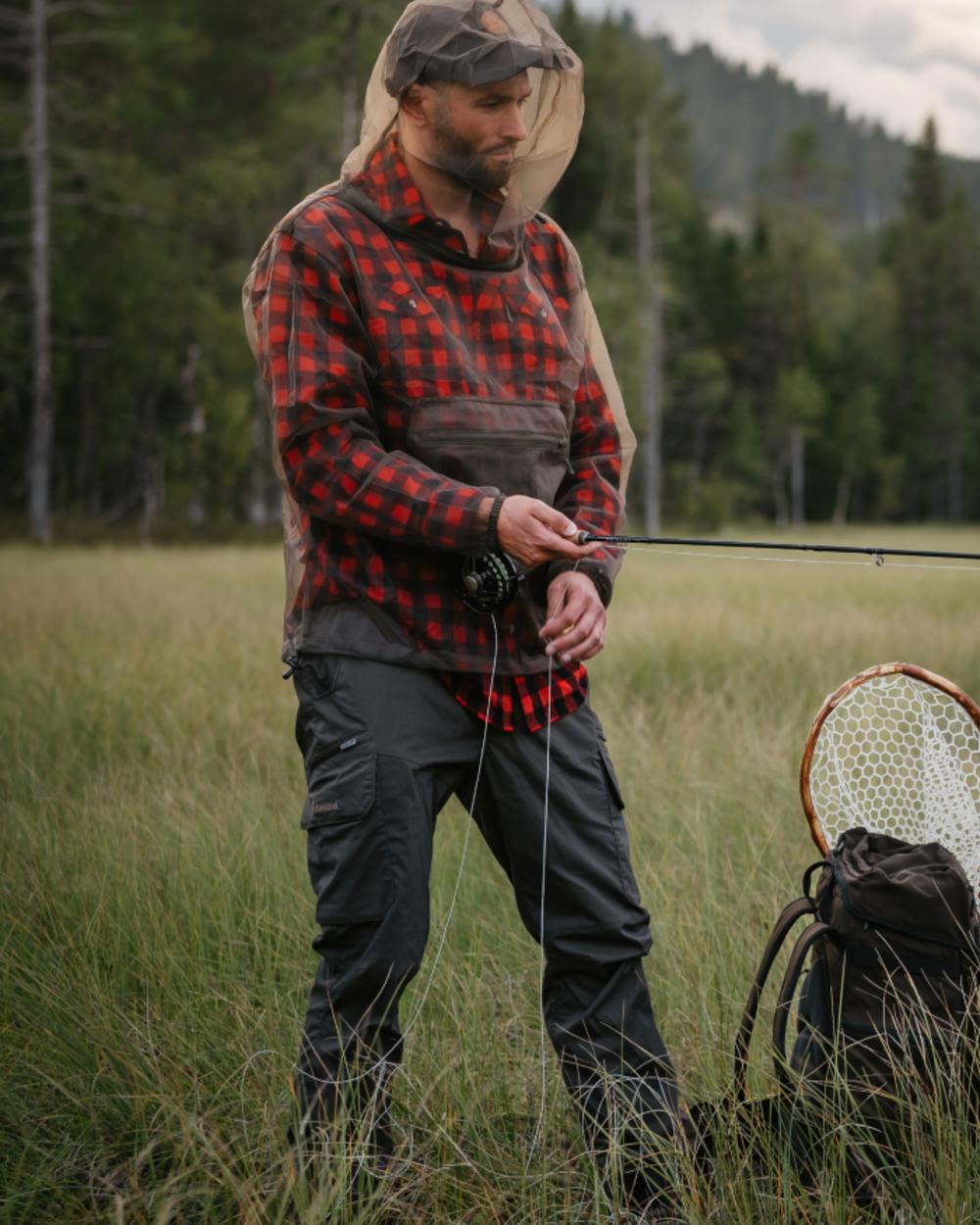 Moss Green coloured Pinewood Mens Smaland Hunters Insectsafe Trousers on forest background 