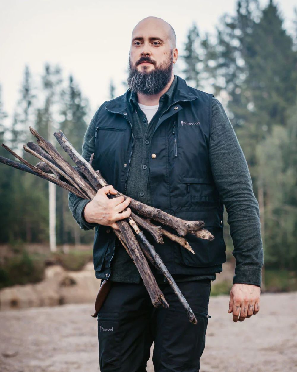 Black coloured Pinewood Mens Tiveden Vest on forest background 