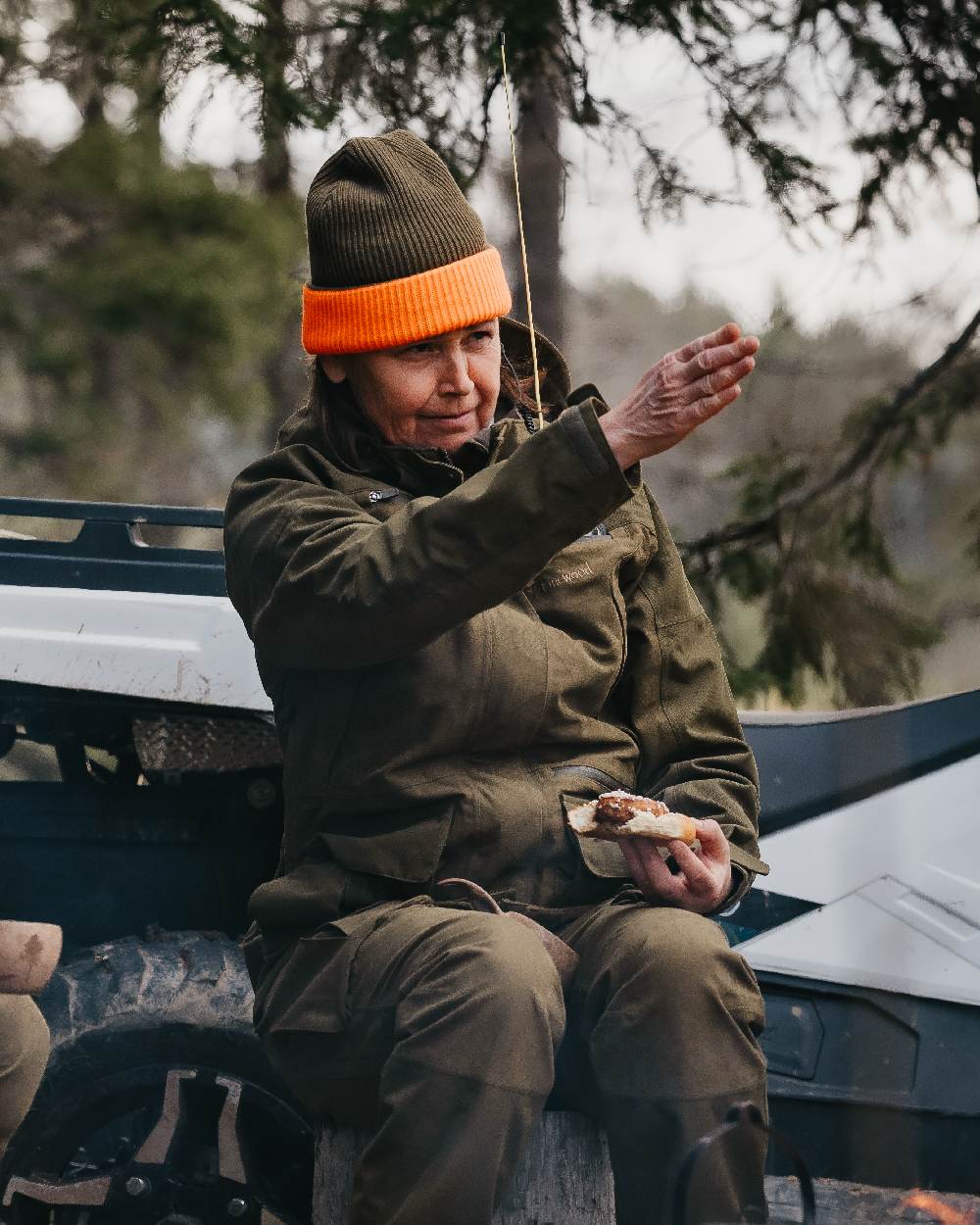 Mossgreen Orange Coloured Pinewood Smaland Reversible Hunters Hat on outdoor background 