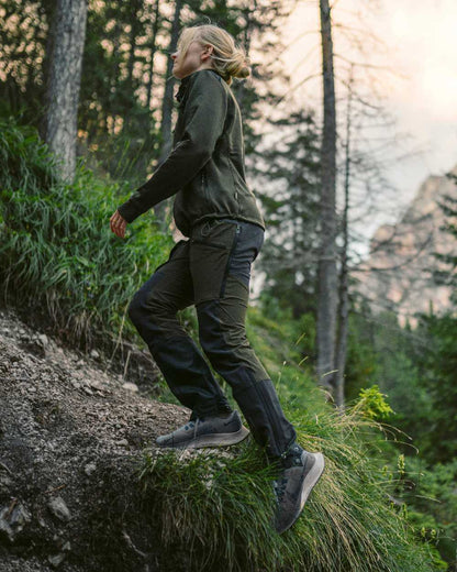 Moss Green Coloured Pinewood Womens Abisko Adventure Trousers on mountain background 