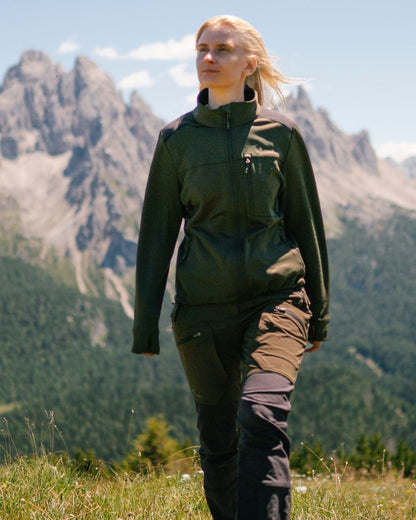 Moss Green Coloured Pinewood Womens Abisko Adventure Trousers on mountain background 