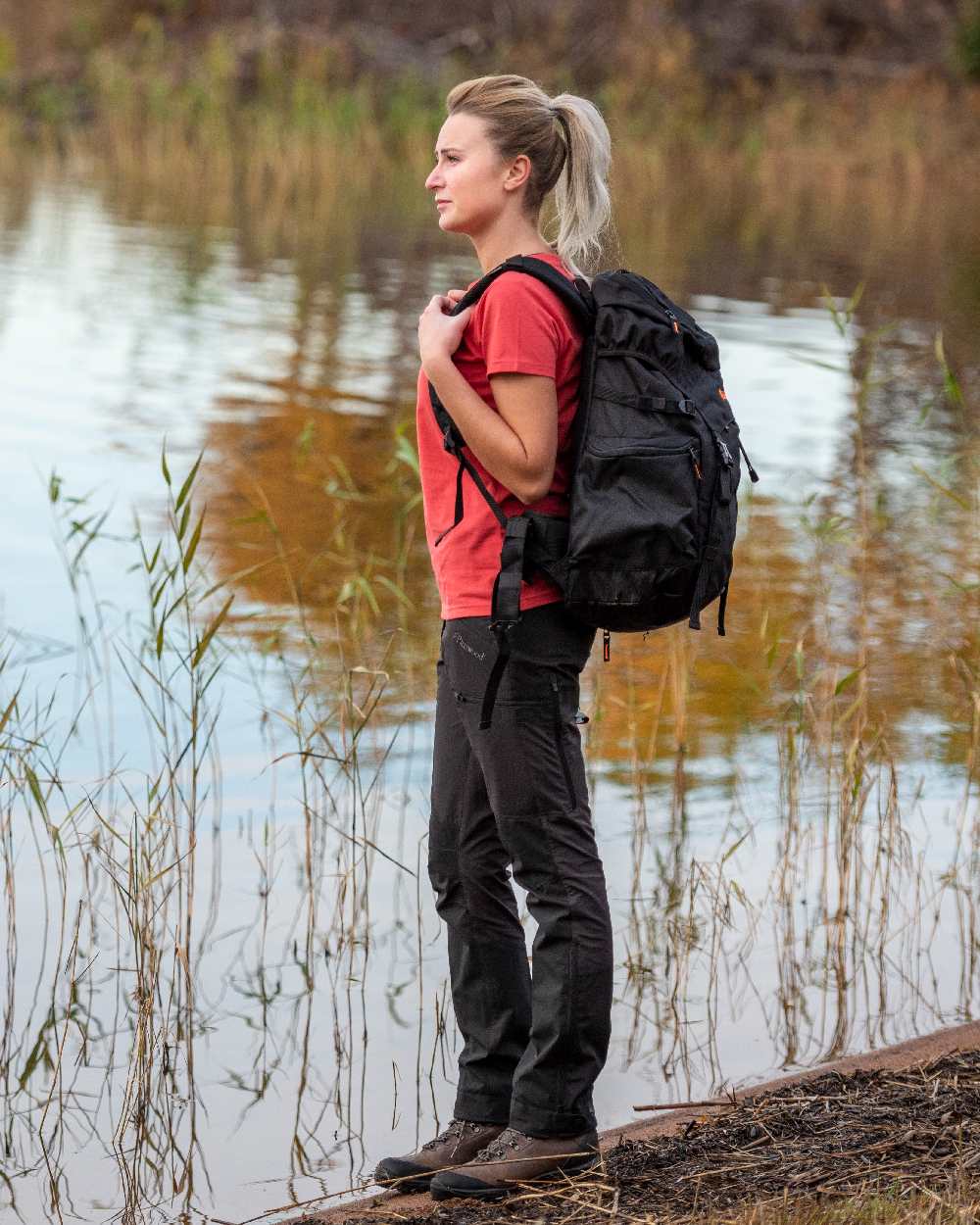 Black Coloured Pinewood Womens Abisko Brenton Trousers on lake background 