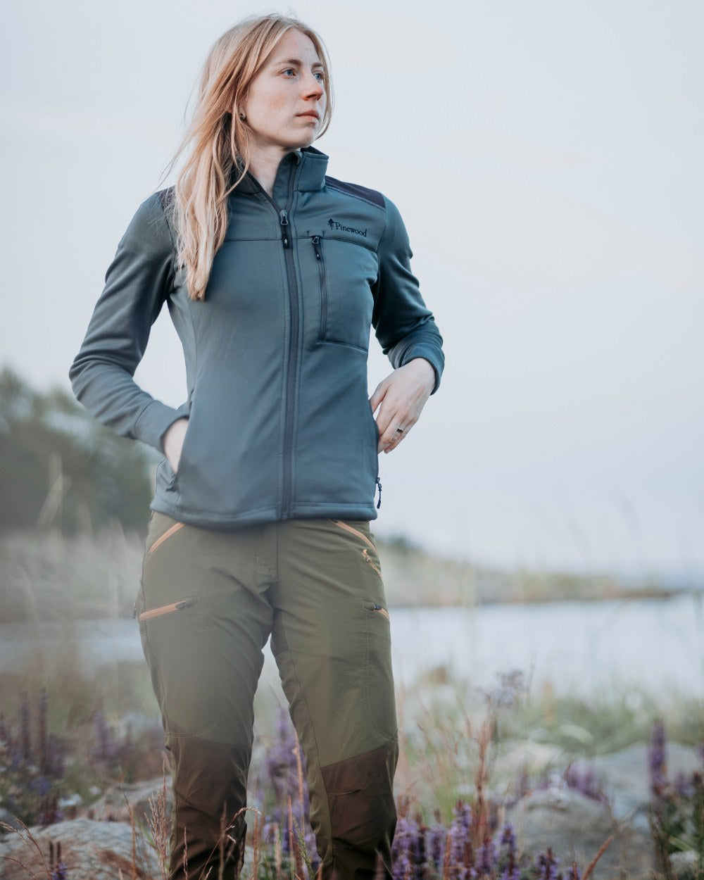 Leaf Hunting Olive Coloured Pinewood Womens Abisko Brenton Trousers on lake background 