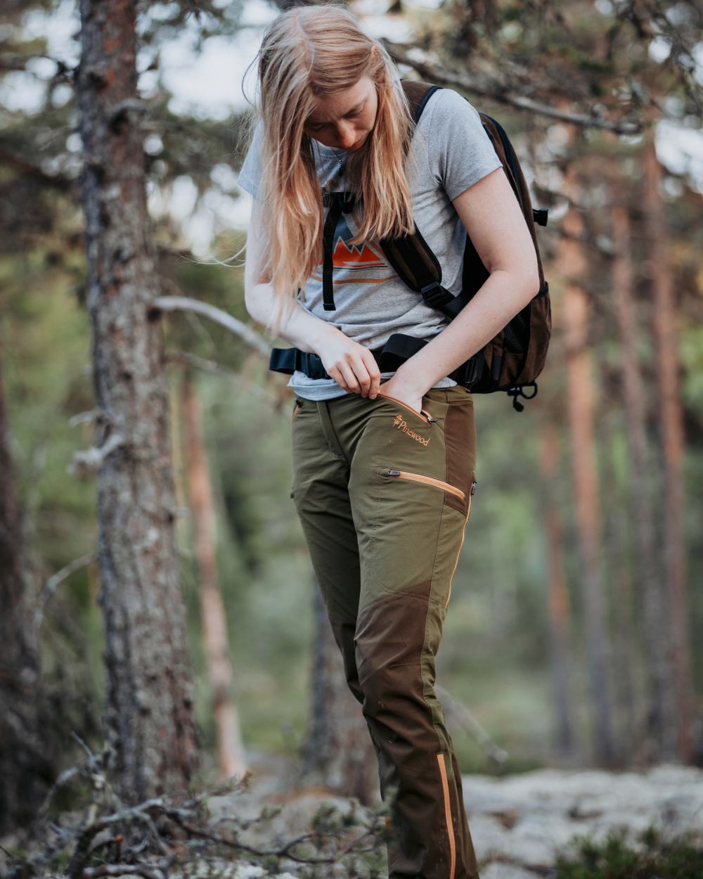 Leaf Hunting Olive Coloured Pinewood Womens Abisko Brenton Trousers on forest background 