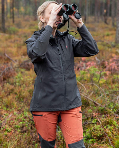 Terracotta Dark Anthracite Coloured Pinewood Womens Abisko Brenton Trousers on forest background 