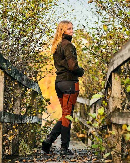 Terracotta Dark Anthracite Coloured Pinewood Womens Abisko Brenton Trousers on forest background 