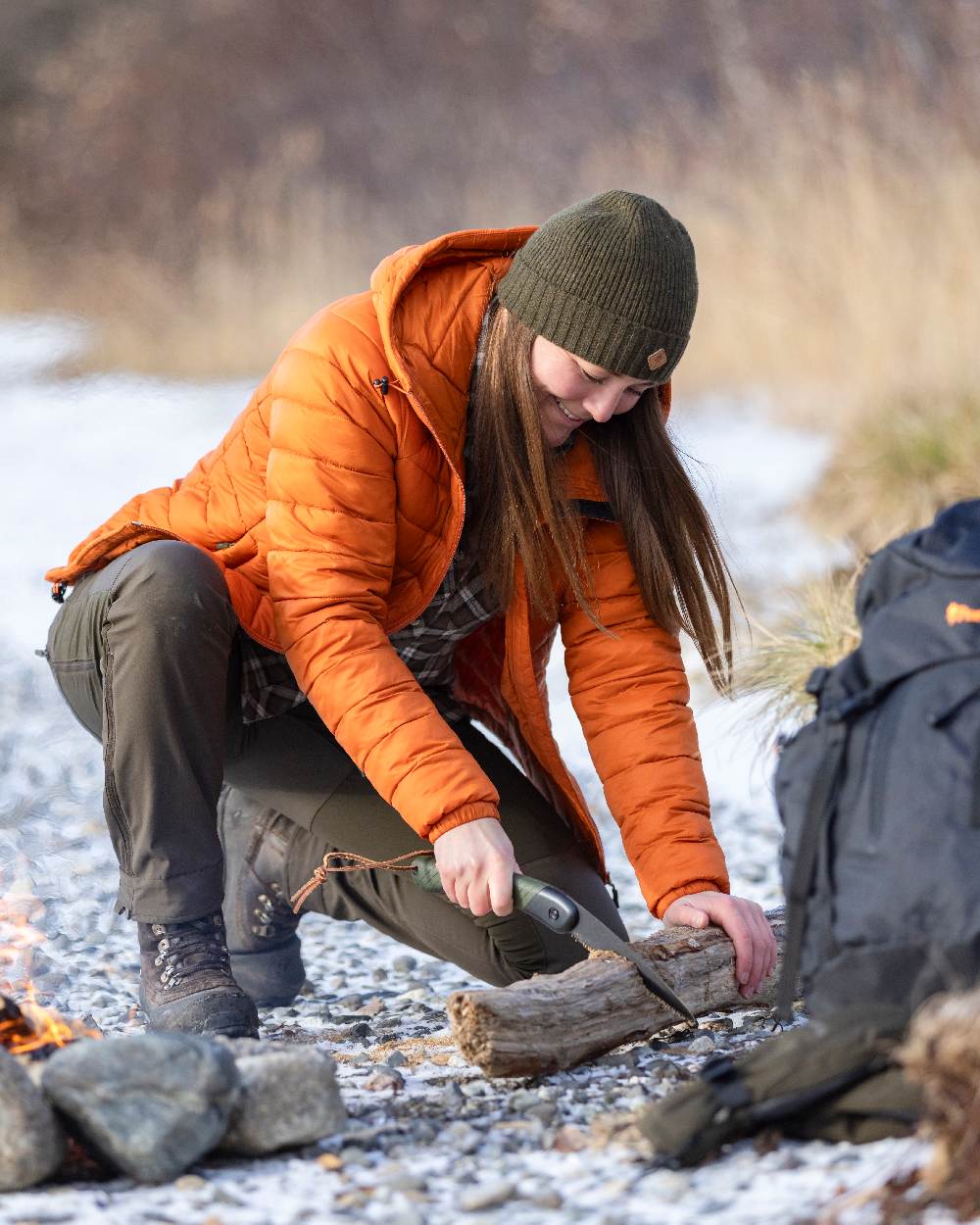 Burned Orange Coloured Pinewood Womens Abisko Insulation Jacket on snow background 