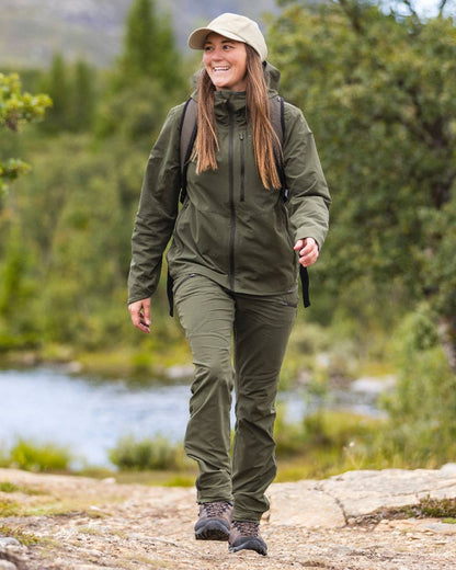 Mossgreen Coloured Pinewood Womens Abisko Light Stretch Trousers on outdoor background 