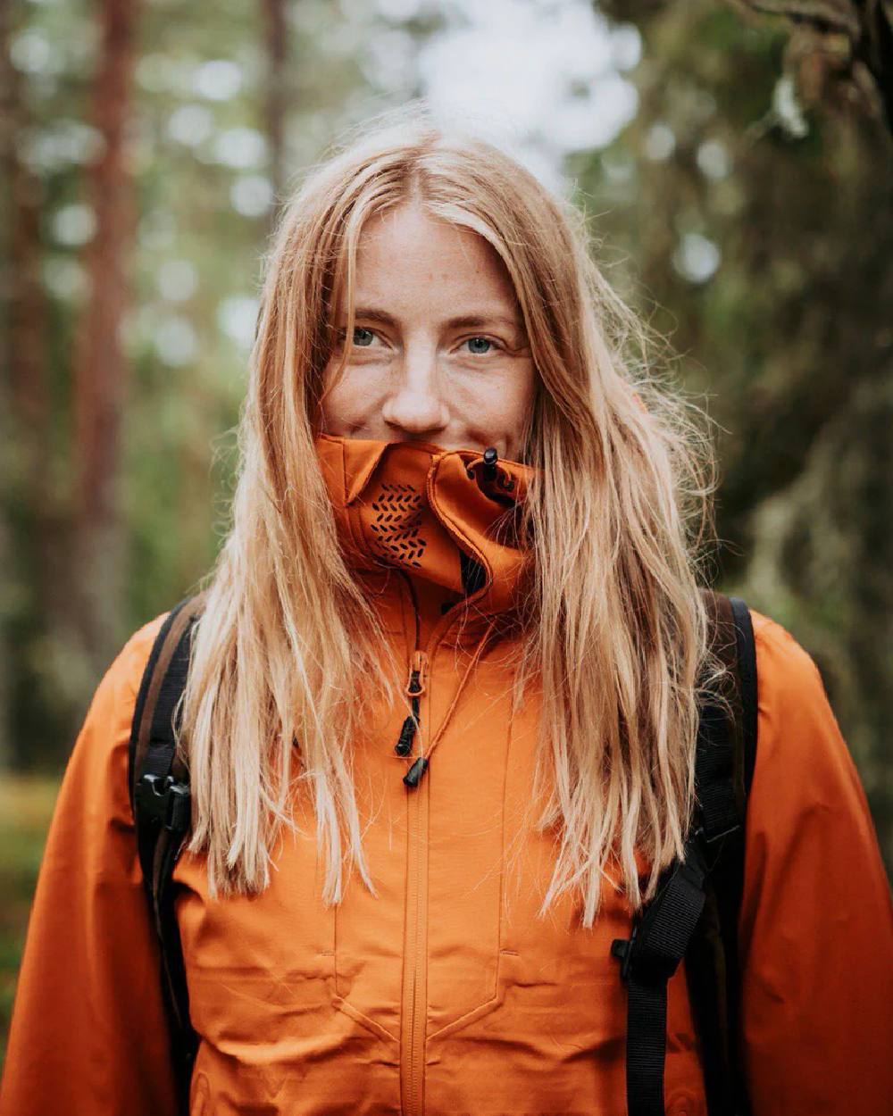 Burned Orange coloured Pinewood Womens Abisko Telluz Three Layer Jacket on blurry background 