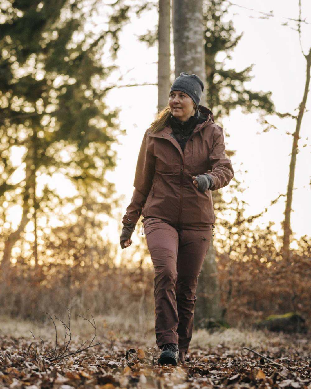 Marron Rose coloured Pinewood Womens Abisko Telluz Three Layer Jacket on forest background 