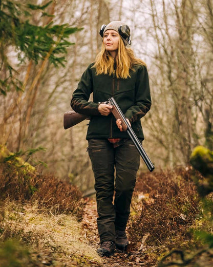 Suede Brown Dark Olive Coloured Pinewood Womens Furudal Caribou Hunt Trousers on forest background 