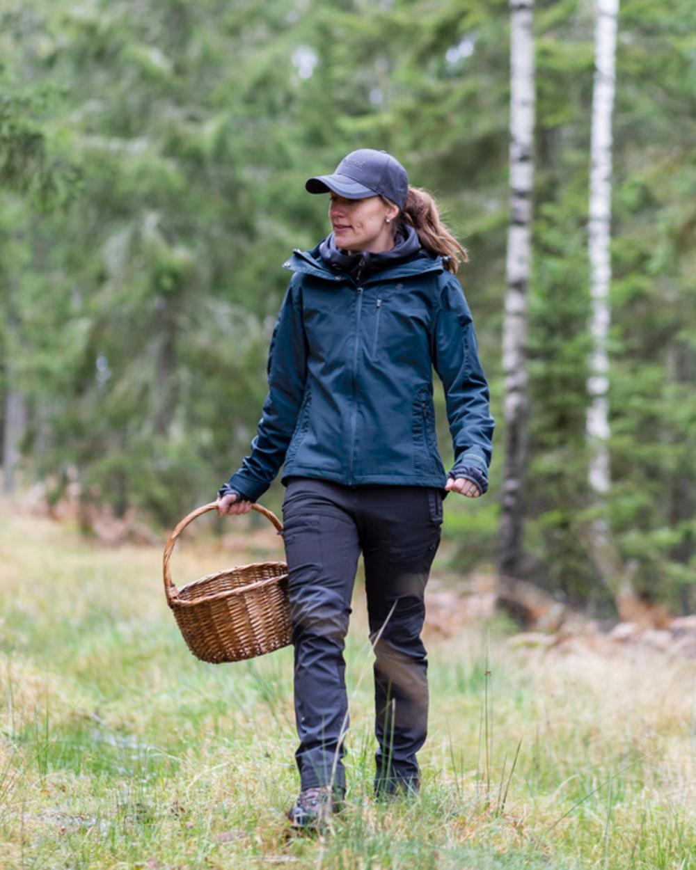 Dark Dive Coloured Pinewood Womens Finnveden Hybrid Extreme Jacket on outdoor background 