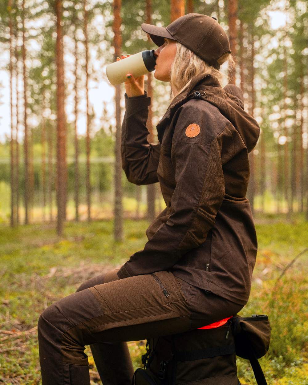 Dark Brown Coloured Pinewood Womens Finnveden Hybrid Jacket on outdoor background 