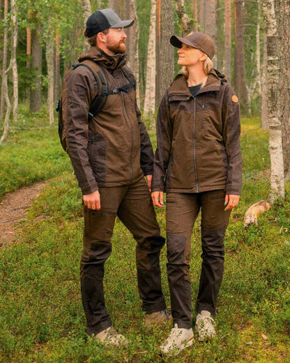 Dark Brown Coloured Pinewood Womens Finnveden Hybrid Jacket on outdoor background 
