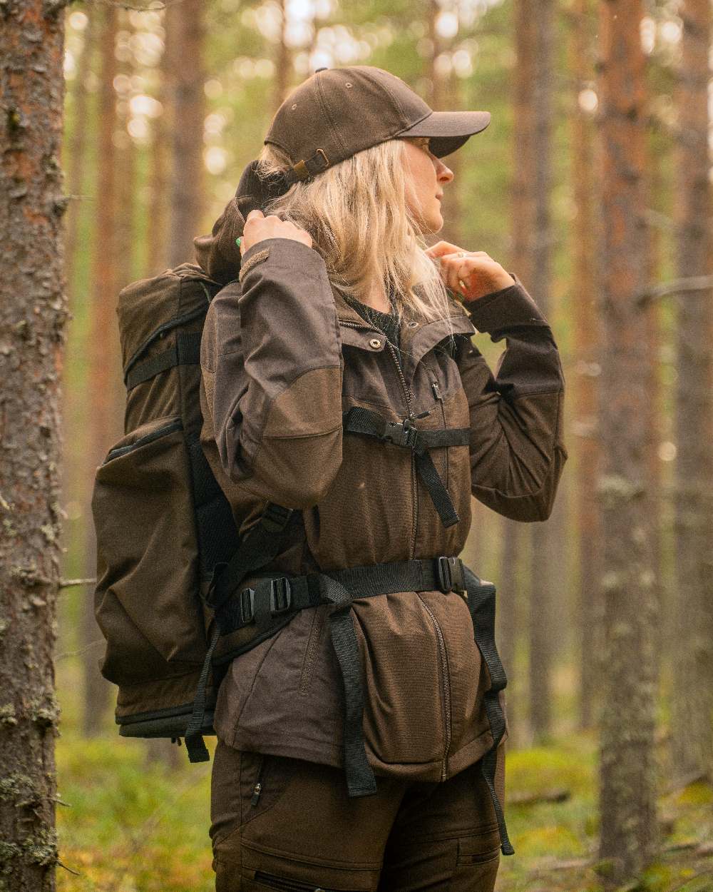 Dark Brown Coloured Pinewood Womens Finnveden Hybrid Jacket on outdoor background 