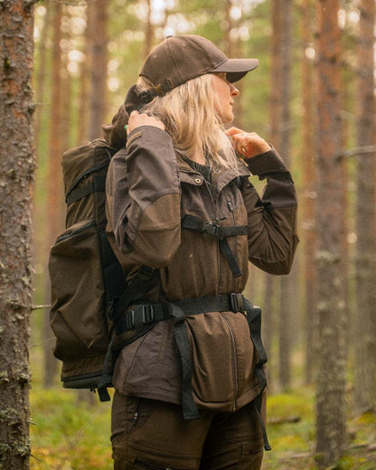 Dark Brown Coloured Pinewood Womens Finnveden Hybrid Jacket on outdoor background 