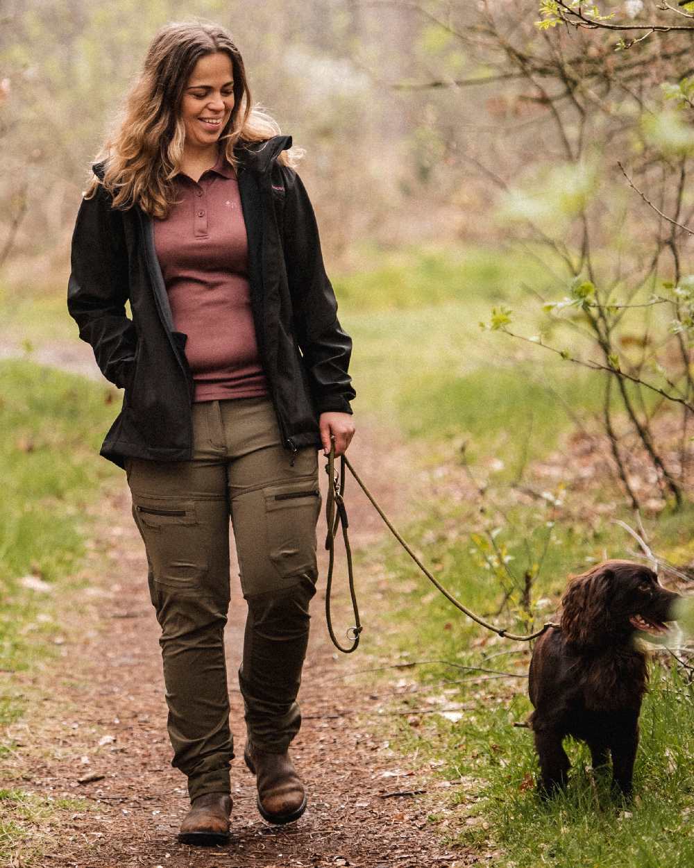 Hunting Olive Coloured Pinewood Womens Finnveden Hybrid Trousers on outdoor background 